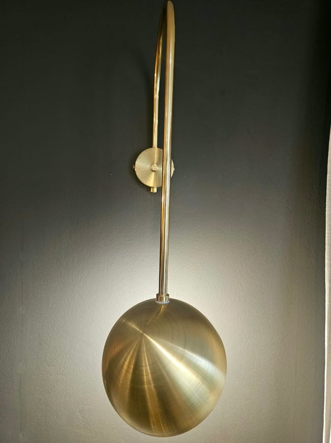 Brass orb wall light